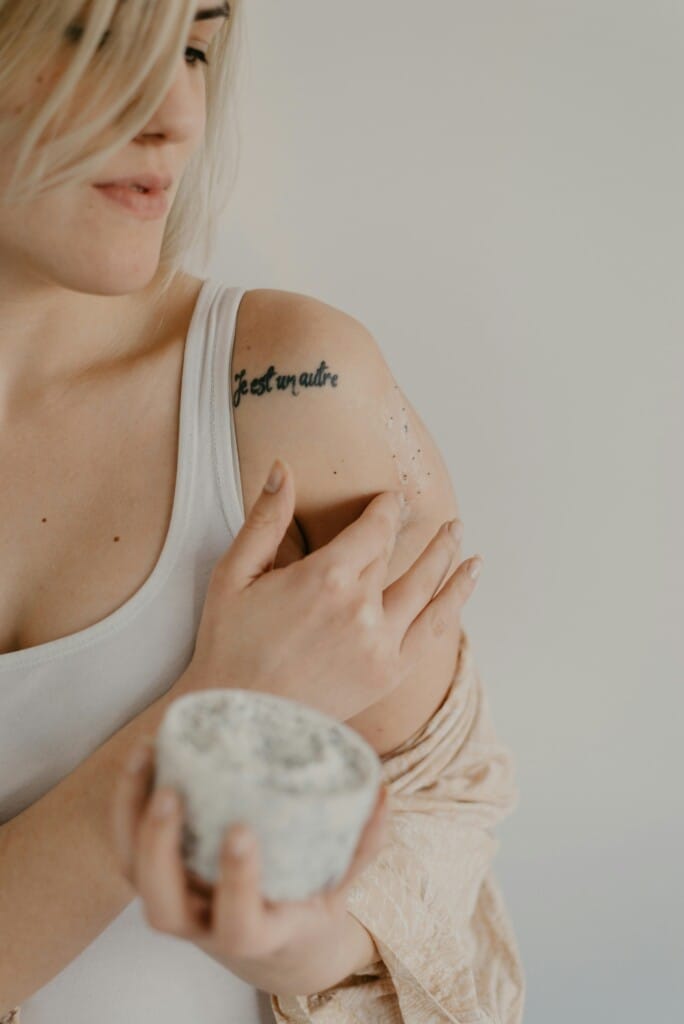 Person Using a Body Scrub on Legs